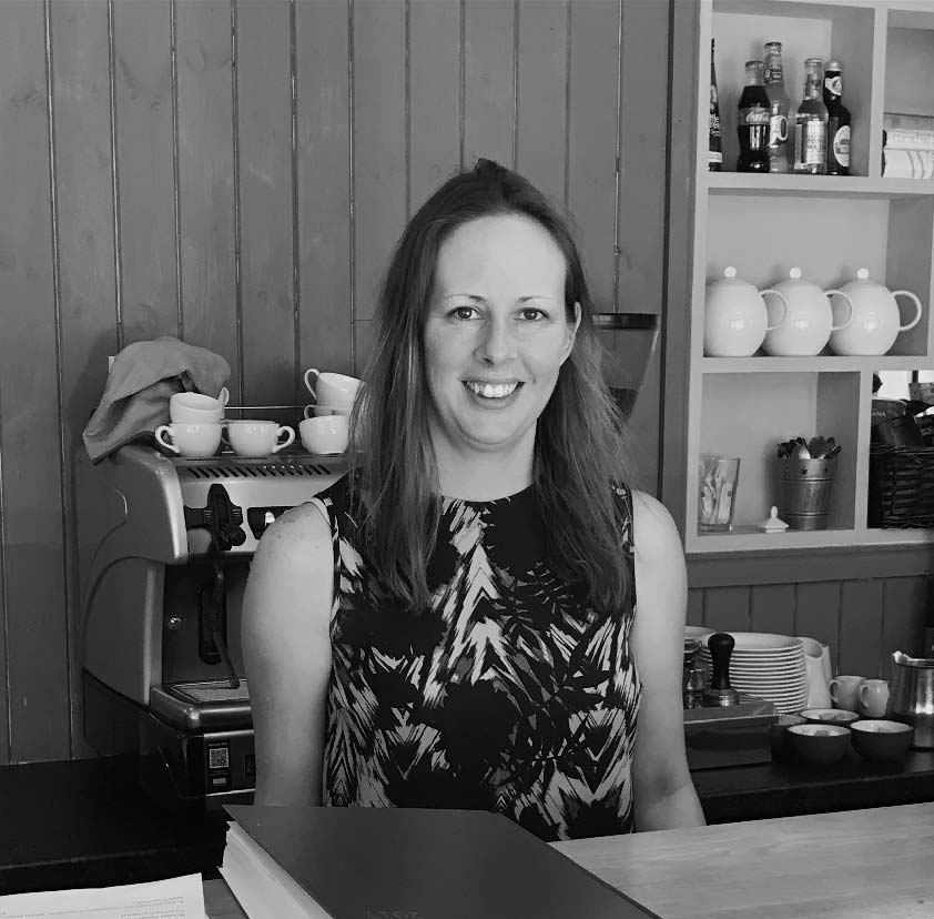 Trudi Luck behind the counter of the restaurant, by the coffee machine